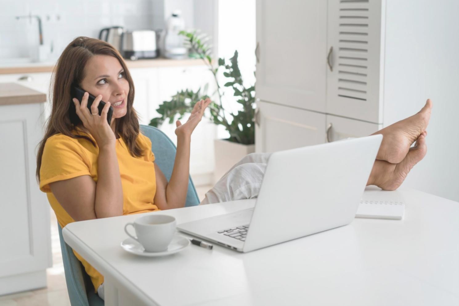Person reviewing financial documents with calculator and notebook